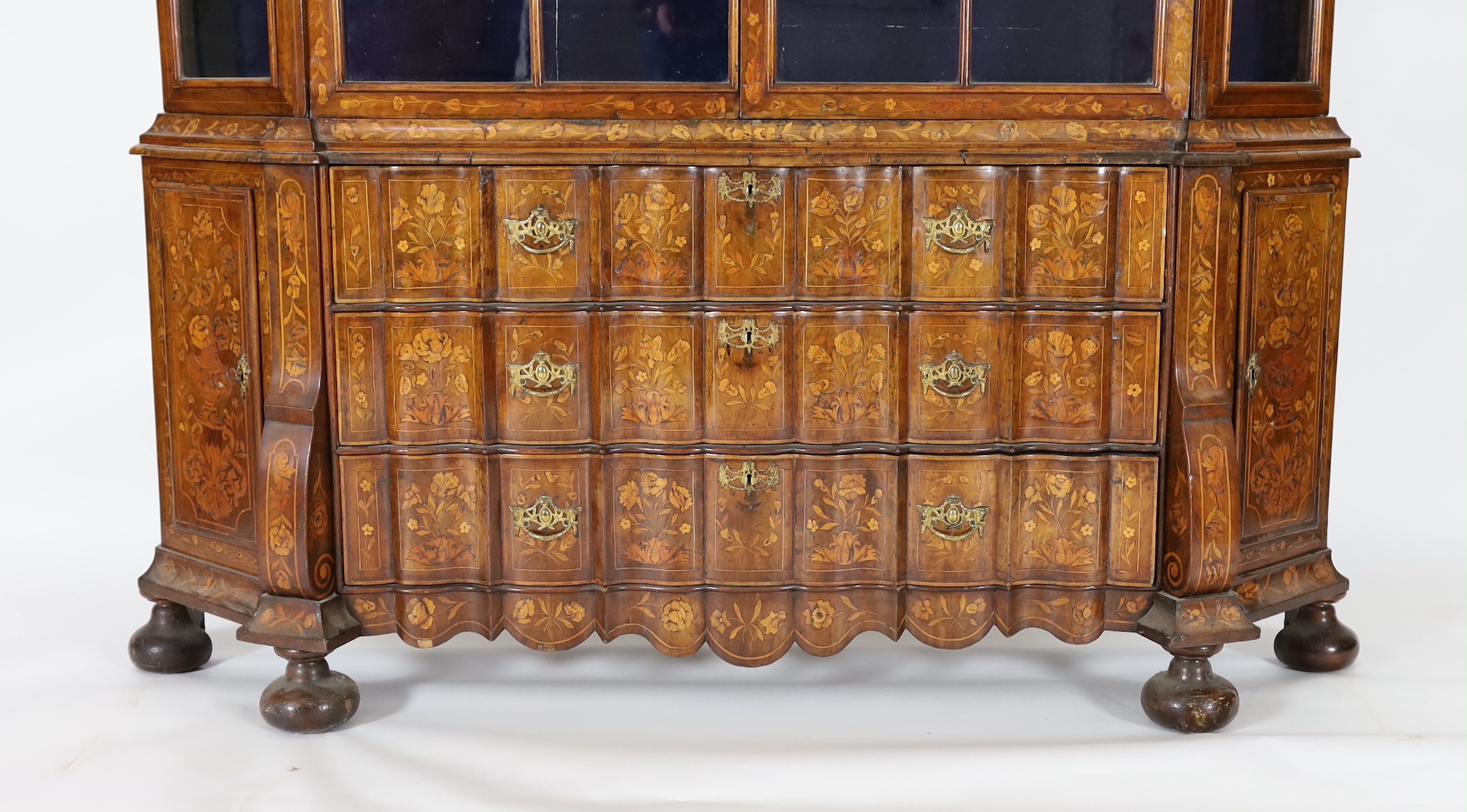 A late 18th century Dutch marquetry inlaid walnut serpentine display cabinet, width 186cm depth 36cm height 260cm